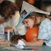 Carpenter Elementary student Olivia Yurcak, 8, rests her chin on a balloon as she colors during the 14th Annual Kids' Fair at University of Michigan on Friday. Melanie Maxwell I AnnArbor.com